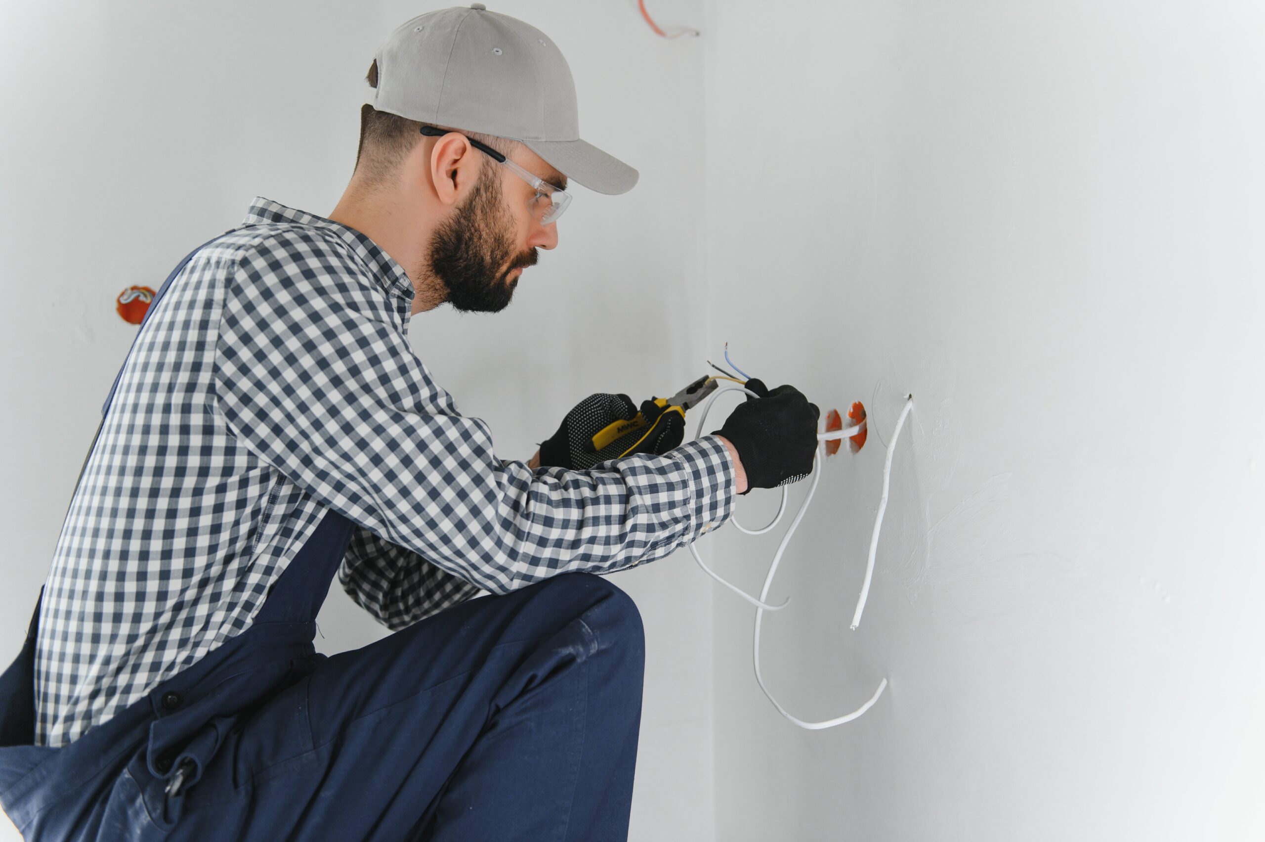man installing outlet in home